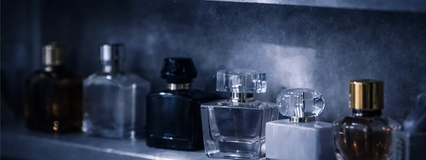 That is a beautifully moody shot of a perfume collection! The cool, atmospheric lighting really highlights the different textures of the glass.