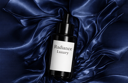 This image uses a radial composition, where the satin fabric seems to swirl around the product like a vortex.